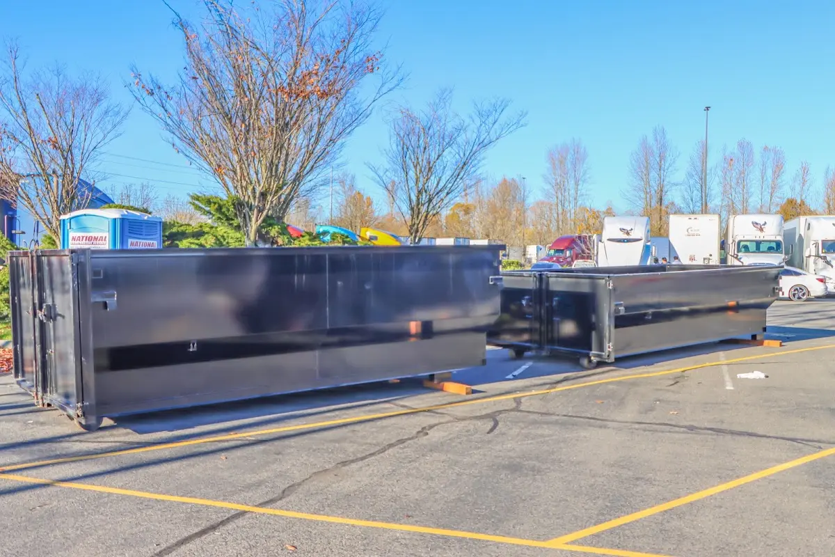 Professional dumpster rental service with roll-off container on residential driveway in Upper Freehold